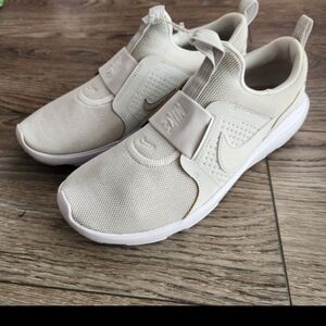 Nike Women's Slip-On Athletic Sneakers in Cream and White with Gold Swoosh